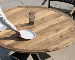 Table de jardin ronde en teck et pieds croisés en aluminium 